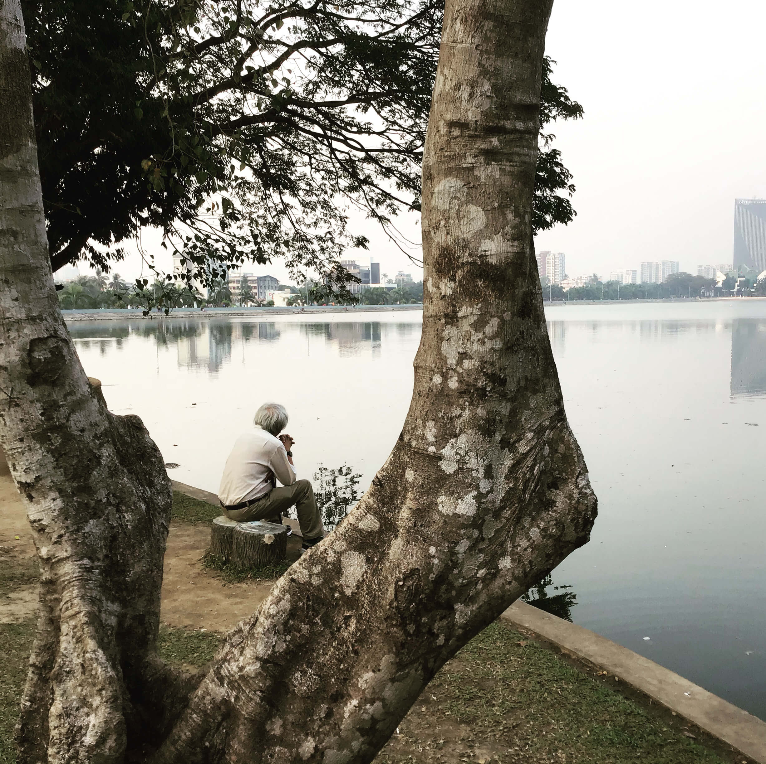 Image of man looking pensivly over Inya Lake